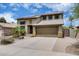 Two-story home featuring desert landscaping, a two-car garage, and solar panels at 7624 E Plata Ave, Mesa, AZ 85212