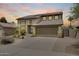 A well-maintained two-story home featuring desert landscaping, a spacious driveway, and a two-car garage at 7624 E Plata Ave, Mesa, AZ 85212