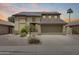 Two-story home featuring desert landscaping, a two-car garage, and solar panels at 7624 E Plata Ave, Mesa, AZ 85212