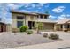 Two-story home featuring desert landscaping, a two-car garage, and solar panels at 7624 E Plata Ave, Mesa, AZ 85212