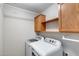 Laundry room featuring washer, dryer, and storage shelves at 7624 E Plata Ave, Mesa, AZ 85212