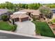 Sprawling home with a lush green lawn, mature trees, and a long driveway at 844 E County Down Dr, Chandler, AZ 85249