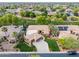An aerial view showcases a well-maintained home with a lush lawn, beautiful landscaping, and a private driveway at 844 E County Down Dr, Chandler, AZ 85249