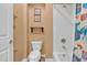 Cozy bathroom showcasing a neutral color scheme, toilet, and shower combo with a decorative shower curtain at 844 E County Down Dr, Chandler, AZ 85249