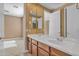 Bathroom featuring a double sink vanity and large mirror, next to another room in the home at 844 E County Down Dr, Chandler, AZ 85249