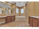 Well-appointed bathroom with wood cabinets, soaking tub, and custom tile accents at 844 E County Down Dr, Chandler, AZ 85249