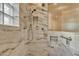 Luxurious bathroom featuring marble-tiled walls, a rainfall showerhead, and glass block window at 844 E County Down Dr, Chandler, AZ 85249