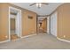 Spacious bedroom featuring neutral carpet, ceiling fan, and access to other rooms at 844 E County Down Dr, Chandler, AZ 85249