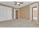 Bedroom with neutral walls and carpet, a ceiling fan, and direct access to two other rooms of the home at 844 E County Down Dr, Chandler, AZ 85249