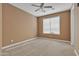 Bedroom featuring neutral carpet, a large window, a ceiling fan and neutral paint colors, providing a calm space at 844 E County Down Dr, Chandler, AZ 85249