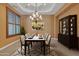 Elegant dining room featuring a chandelier, stylish rug, and seating for six guests at 844 E County Down Dr, Chandler, AZ 85249