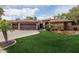 Beautiful home with a well-manicured lawn and a three-car garage at 844 E County Down Dr, Chandler, AZ 85249
