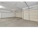 Garage with multiple garage doors, white walls and storage cabinets at 844 E County Down Dr, Chandler, AZ 85249