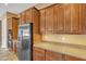 Kitchen features stainless steel refrigerator, double ovens, and plentiful cabinet storage at 844 E County Down Dr, Chandler, AZ 85249