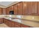 Well-equipped kitchen with sleek countertops, custom cabinets, and modern appliances at 844 E County Down Dr, Chandler, AZ 85249