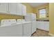 Laundry room featuring white cabinets, washer, dryer, utility sink, and tile flooring at 844 E County Down Dr, Chandler, AZ 85249