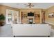 Bright living room featuring a fireplace, built-in shelving, and access to the backyard at 844 E County Down Dr, Chandler, AZ 85249