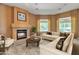 Comfortable living room with a cozy fireplace, natural light, and modern furnishings at 844 E County Down Dr, Chandler, AZ 85249