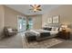 Inviting main bedroom featuring French doors, a gray headboard, and a plush upholstered bench at 844 E County Down Dr, Chandler, AZ 85249