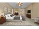 Beautiful main bedroom with a ceiling fan, ensuite, a gray headboard, and wood furnishings at 844 E County Down Dr, Chandler, AZ 85249