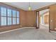 Office space with a large window, neutral carpet, and soft lighting, creating a calm and professional environment at 844 E County Down Dr, Chandler, AZ 85249