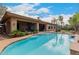 Private backyard oasis with a sparkling pool, covered patio, and lush landscaping at 844 E County Down Dr, Chandler, AZ 85249