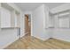 Spacious walk-in closet with custom shelving and wood-look flooring offers ample storage and organization options at 844 E County Down Dr, Chandler, AZ 85249