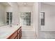 Bathroom features dual sink vanity, soaking tub, tile floors and a glass block window at 1019 N Monterey St, Gilbert, AZ 85233