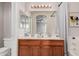 Well-lit bathroom with a dual sink vanity, framed mirrors, and a shower-tub combination, ideal for a modern lifestyle at 1019 N Monterey St, Gilbert, AZ 85233