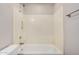 Bathroom bathtub with shower featuring built in shelves and a towel bar at 1019 N Monterey St, Gilbert, AZ 85233