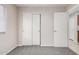 Bedroom with plush carpet, a window, closet, and a door at 1019 N Monterey St, Gilbert, AZ 85233
