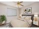 Cozy bedroom with neutral decor, a comfortable bed, and a ceiling fan, perfect for relaxation and restful nights at 1019 N Monterey St, Gilbert, AZ 85233