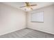 Neutral bedroom featuring plush carpet, a window, and ceiling fan at 1019 N Monterey St, Gilbert, AZ 85233