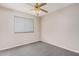 Comfortable bedroom featuring plush carpet, a window, and ceiling fan at 1019 N Monterey St, Gilbert, AZ 85233