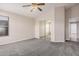Spacious bedroom features neutral carpet, paint, large closet with mirrored doors and ceiling fan at 1019 N Monterey St, Gilbert, AZ 85233