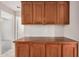 Kitchen wet bar features wood cabinets and countertops plus bonus storage at 1019 N Monterey St, Gilbert, AZ 85233