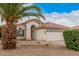 Single-Gathering home with desert landscaping, a two-car garage and a beautiful palm tree at 1019 N Monterey St, Gilbert, AZ 85233