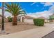 Single-Gathering home with desert landscaping, a two-car garage and a beautiful palm tree at 1019 N Monterey St, Gilbert, AZ 85233