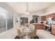 Charming eat-in kitchen with stainless steel appliances, wood cabinets, and sliding glass doors leading to the outdoor patio at 1019 N Monterey St, Gilbert, AZ 85233