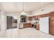Spacious kitchen features updated appliances, tile flooring and sliding glass doors to the backyard at 1019 N Monterey St, Gilbert, AZ 85233