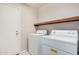 Bright laundry room featuring white washer and dryer appliances at 1019 N Monterey St, Gilbert, AZ 85233
