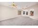 Light and airy living room with carpet flooring, arched doorways, and ceiling fans at 1019 N Monterey St, Gilbert, AZ 85233