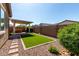 Private backyard featuring artificial turf, a covered patio, and a hot tub at 10307 E Tiburon Ave, Mesa, AZ 85212