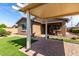 Landscaped backyard with covered patio, artificial turf, and low-maintenance design at 10307 E Tiburon Ave, Mesa, AZ 85212