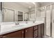 Bathroom with double sinks, wood cabinets, and glass enclosed shower at 10307 E Tiburon Ave, Mesa, AZ 85212