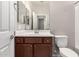 Clean bathroom with vanity cabinet, single sink, large mirror, and toilet at 10307 E Tiburon Ave, Mesa, AZ 85212