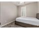 Cozy bedroom with neutral carpeting and a plantation shutter window at 10307 E Tiburon Ave, Mesa, AZ 85212