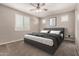 Comfortable bedroom with ceiling fan, plantation shutters, and a plush bed at 10307 E Tiburon Ave, Mesa, AZ 85212