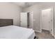 Bedroom with neutral carpet, walk-in closet, and a three-panel door leading to the hall at 10307 E Tiburon Ave, Mesa, AZ 85212