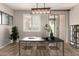 Bright dining area with modern lighting, table setting, and sliding door access to the patio at 10307 E Tiburon Ave, Mesa, AZ 85212